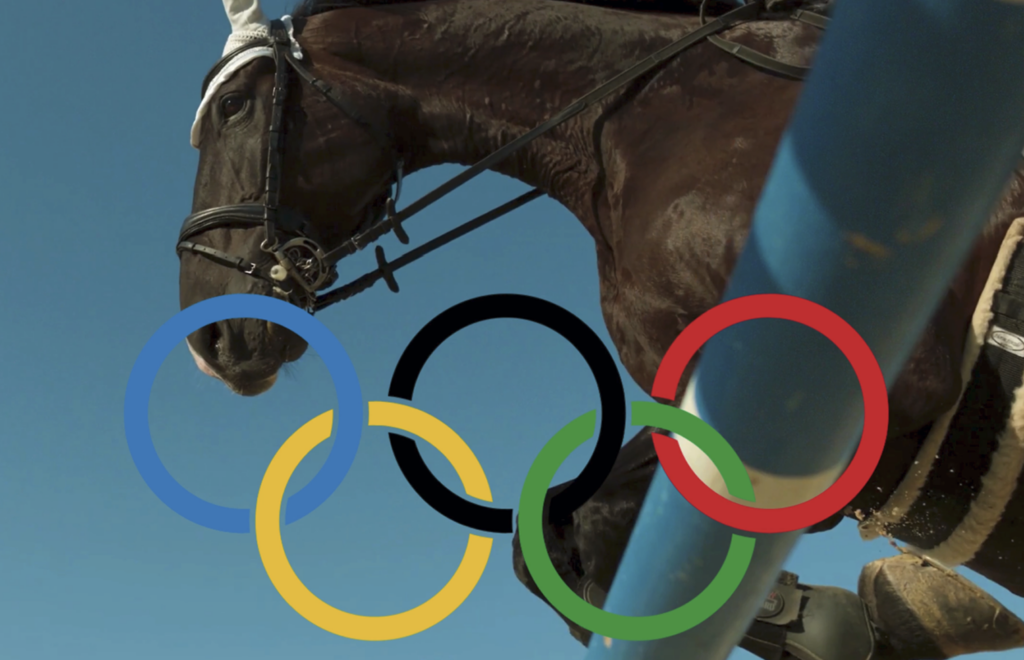 Show jumping, olympic rings and blue skies